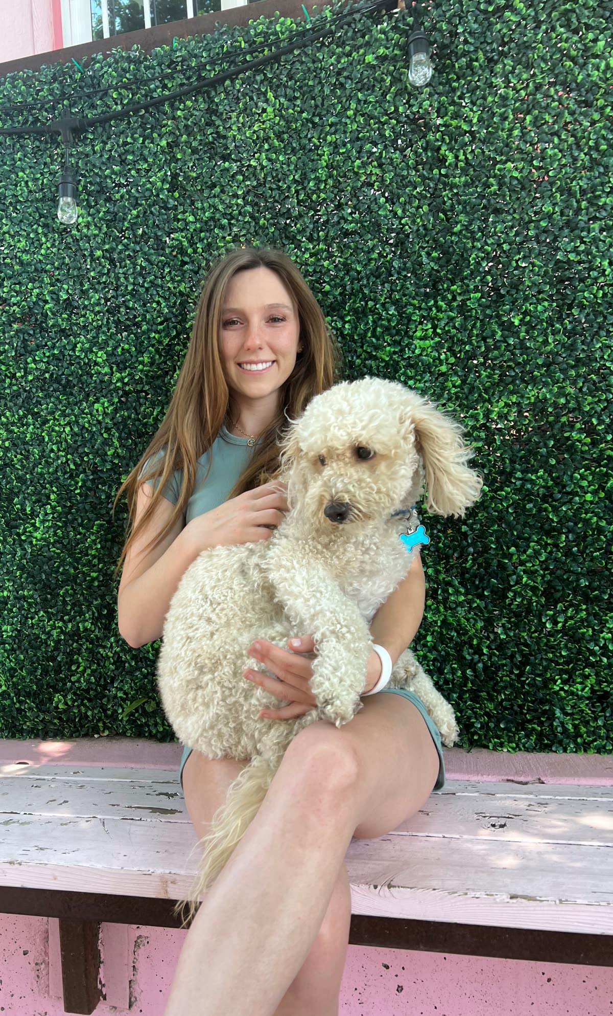 Ashton Gerardi, OTR, OTD, holding a white poodle